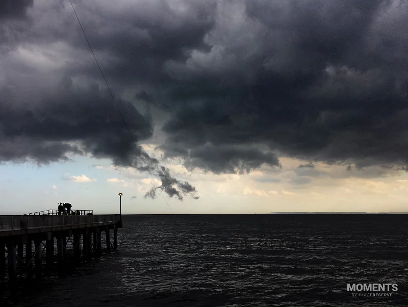 Dramatic Storm Clouds Over a Coastal Pier