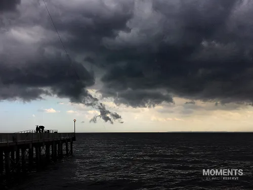 Dramatic Storm Clouds Over a Coastal Pier