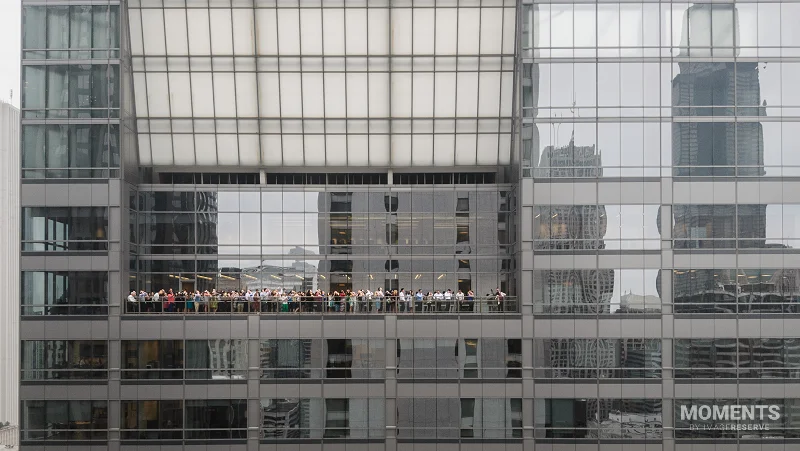People Watching the Solar Eclipse from a Skyscraper Balcony
