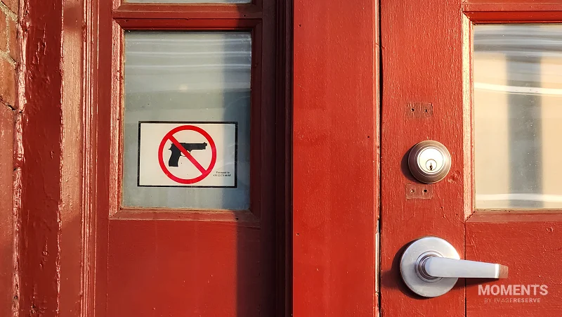 "No Guns" Sign on a Red Train Station Door in Illinois