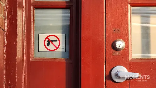 "No Guns" Sign on a Red Train Station Door in Illinois